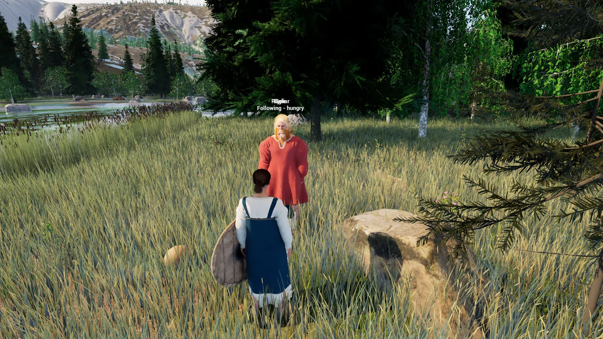 A shield-maiden walking towards a Viking by a lake