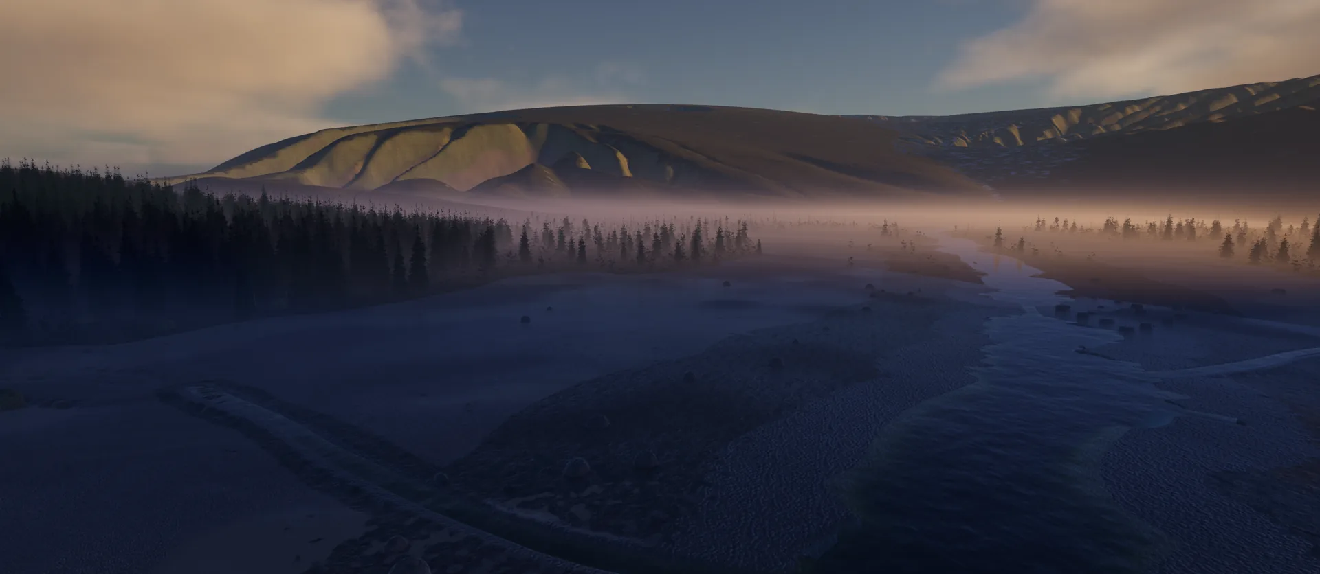 A valley at dusk with a river, mist lying over the forest and the last sun on the mountain slopes